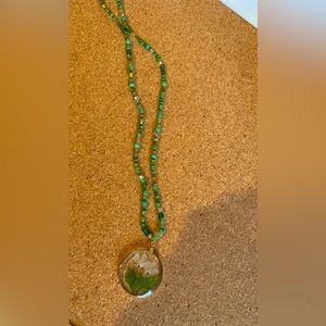 green seed bead necklace made with resin finished wisteria flowers.